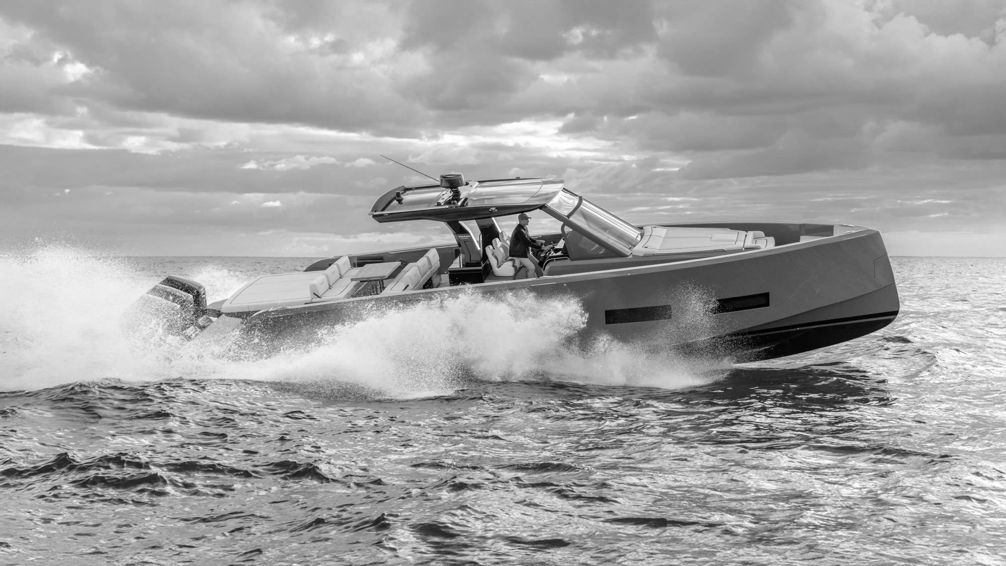 Luxury motor yacht cruising past Mallorca cliffs at golden hour